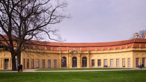 a large building with a tree in front of it at Garner Hotel Erlangen Süd by IHG in Erlangen