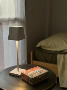 a table with a lamp and a book on it at Tra Cielo e Mare da Vale in Fano +17 photos