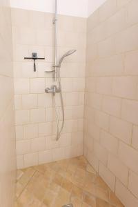 a shower in a bathroom with a tiled floor at Le Mas Du Loup in Moustiers-Sainte-Marie +34 photos