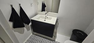 a bathroom with a white sink and a mirror at Riverside villa with sauna and jacuzzi in Rovaniemi