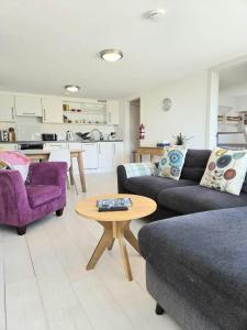 a living room with two couches and a table at Millendreath Oean View Villa in Saint Martin