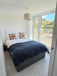 a bedroom with a large bed and a large window at Millendreath Oean View Villa in Saint Martin