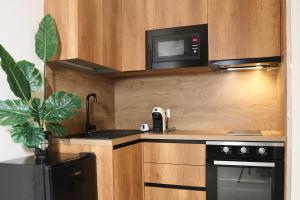 a kitchen with a microwave and a stove at Luxe Living Studio in Tirana