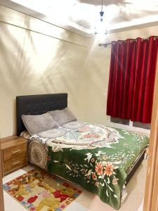 a bedroom with a bed and a red curtain at Appartement agadir centre in Agadir +55 photos