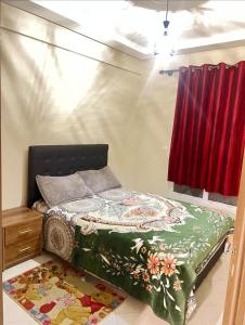 a bedroom with a bed and a red curtain at Appartement agadir centre in Agadir