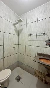 a bathroom with a toilet and a sink at Minas Hotel Uberlândia in Uberlândia +24 photos