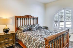 a bedroom with a bed and a lamp and a window at Groups Welcome! Home w/ Pool + Patio in N Phoenix in Phoenix +32 photos