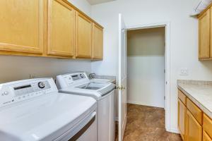 a laundry room with a washer and dryer at Groups Welcome! Home w/ Pool + Patio in N Phoenix in Phoenix