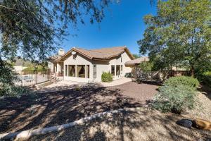 a house with a fence and a yard at Groups Welcome! Home w/ Pool + Patio in N Phoenix in Phoenix