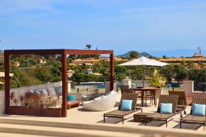 ブジオスにあるPousada Gammel Dansk by Latitud Hotelesのパティオ(椅子、テーブル、パラソル付)