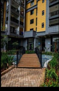 a wooden walkway in front of a building at Studio apartment in Gatunga
