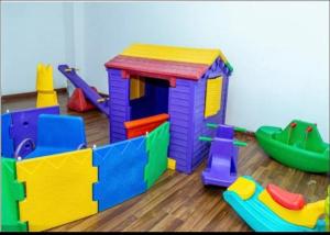 a play room with a toy house and other toys at Studio apartment in Gatunga