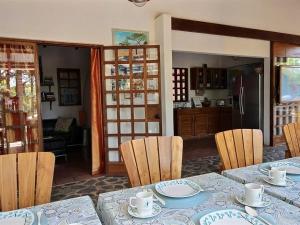 a dining room with a table and chairs at The Beach Bungalows Tamarindo- Adults Only in Tamarindo