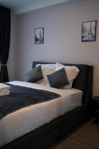 a bedroom with a bed with pillows on it at Hôtel Sofiane in Paris