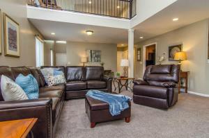 a living room with a leather couch and chairs at Union Grove in Salt Lake with Hot Tub and Foosball in Midvale