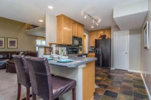 a kitchen and living room with a counter and chairs at Union Grove in Salt Lake with Hot Tub and Foosball in Midvale