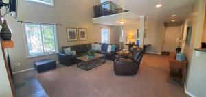 a living room with a couch and a table at Union Grove in Salt Lake with Hot Tub and Foosball in Midvale +37 photos