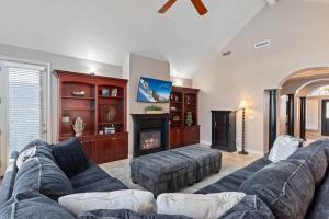 a living room with a couch and a fireplace at Riviera Retreat in Salt Lake with Private Hot Tub and Theater in Millcreek