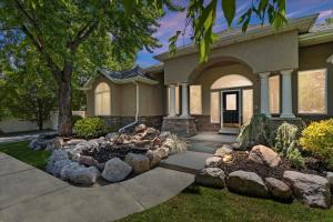 a house with a fire pit in the front yard at Riviera Retreat in Salt Lake with Private Hot Tub and Theater in Millcreek
