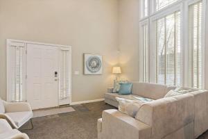 a living room with a couch and chairs and windows at Union Park in Salt Lake with Hot Tub Near Park in Midvale