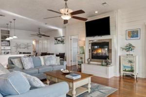 a living room with a couch and a fireplace at Paradise Beachfront Firepit Couples Retreat in Caplen