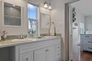 a bathroom with two sinks and a large mirror at Paradise Beachfront Firepit Couples Retreat in Caplen +46 photos