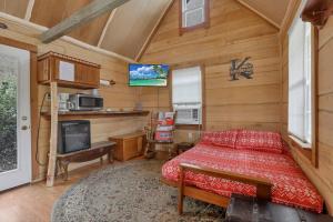 a bedroom with a bed and a tv in a room at Cozy Cabin in New Lexington
