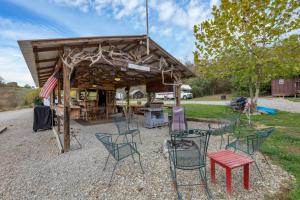 a group of chairs and tables in front of a building at Cozy Cabin in New Lexington