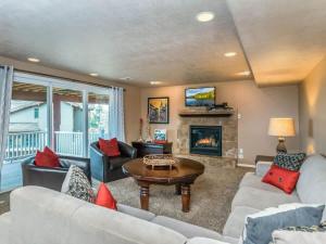 a living room with couches and a fireplace at Wasatch Retreat in Draper with Mtn Views Theater and Hot Tub in Draper