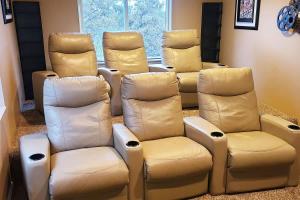 a room filled with white leather chairs and a window at Wasatch Retreat in Draper with Mtn Views Theater and Hot Tub in Draper +45 photos