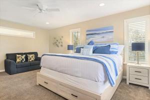 a bedroom with a large bed and a couch at Union Duplex in Salt Lake with Hot Tub and Park in Midvale