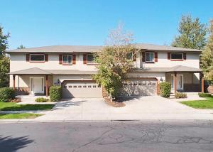 a large house with a garage and a driveway at Union Duplex in Salt Lake with Hot Tub and Park in Midvale
