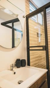 a bathroom with a sink and a mirror at 3-bedroom The Dream House - Herradura & Los Sueños Getaway in Herradura