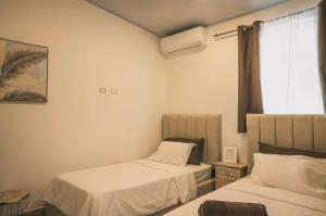 a room with two beds and a window at 3-bedroom The Dream House - Herradura & Los Sueños Getaway in Herradura +36 photos