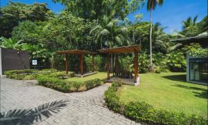 a pavilion in a park with trees and grass at 3-bedroom The Dream House - Herradura & Los Sueños Getaway in Herradura