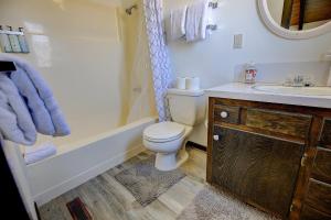 a bathroom with a toilet and a tub and a sink at The ranch house #2501 in Sugarloaf +16 photos