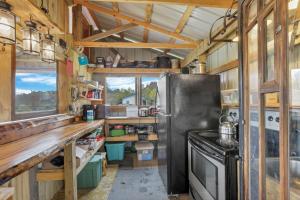 a kitchen with a refrigerator and a stove at Cabin with Character in New Lexington