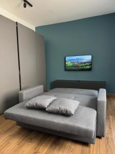 a bedroom with a bed with a tv on the wall at Modern Studio in Central Victoria in Victoria