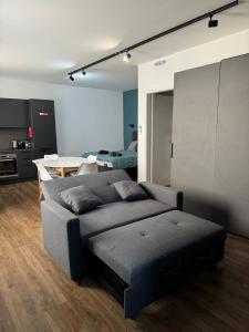 a living room with a couch and a table at Modern Studio in Central Victoria in Victoria