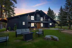 a black house with a fire pit in the yard at The ranch house #2501 in Sugarloaf