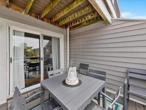 a table and chairs on the porch of a house at Seabreeze village 5 in Dewey Beach
