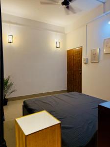 a bedroom with a bed and a cabinet and a door at StelaCasa Homestay in Tezpur