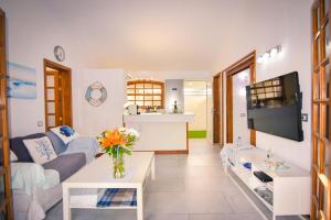 a living room with a couch and a table at Wonderful Bungalow in Maspalomas in Maspalomas
