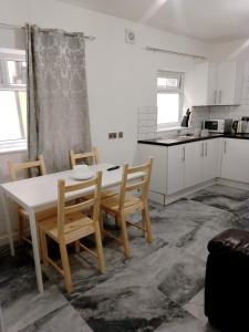 a kitchen with a table and chairs in a room at Modern 2 bedrooms Apartment- Ashton-Under-Lyne- Hosts 5 persons in Ashton under Lyne