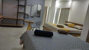 a hotel room with two beds and a bag on the bed at Hotel Filigrana Mompox in Mompos