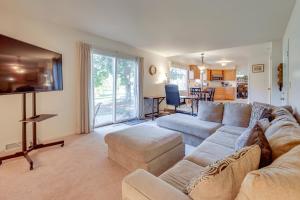 a living room with a couch and a flat screen tv at 3 Mi to Dtwn Home with Fire Pit and Yard in Jackson in Jackson