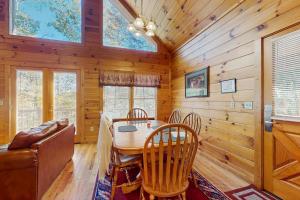 a dining room with a table and chairs at Hickory Hill in Pigeon Forge