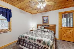 a bedroom with a bed and a ceiling fan at Hickory Hill in Pigeon Forge