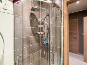 a shower with a glass door in a bathroom at Zeezicht GV in Galopen +6 photos