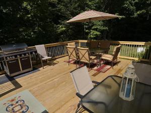 a deck with a table and chairs and an umbrella at Ole and Lena's Place in Bayfield